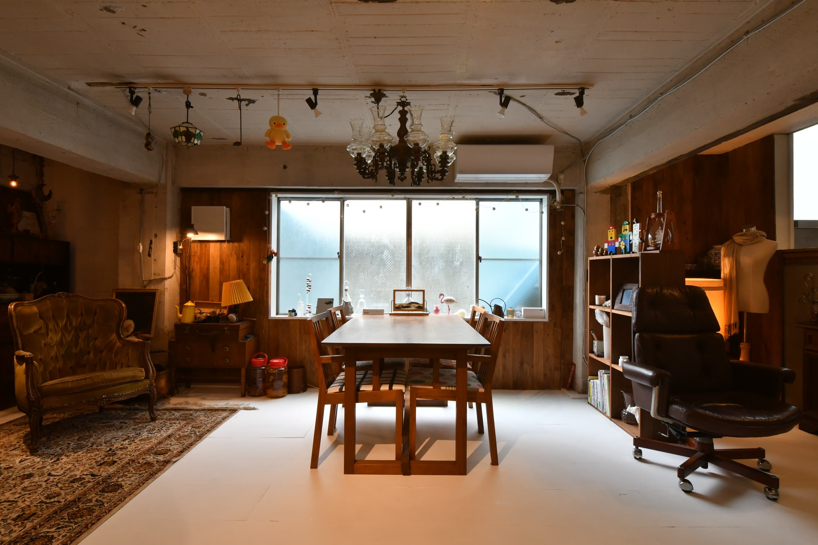 4人がけのダイニングテーブルセットです。木製のシャンデリアも存在感があります。